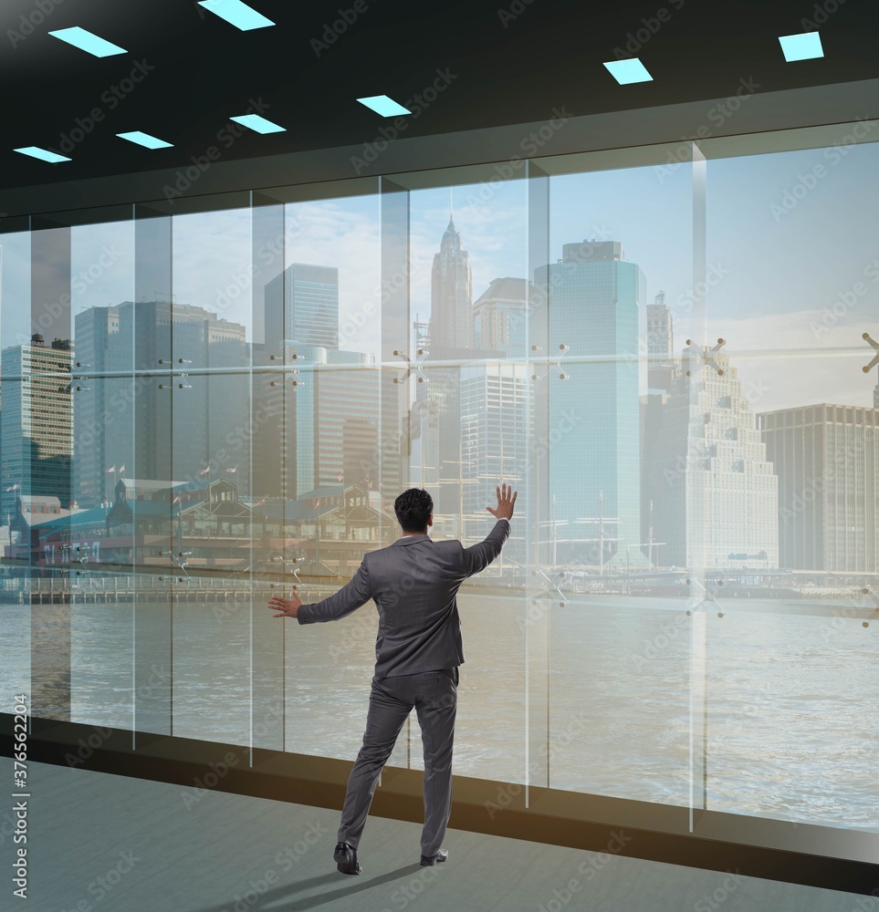 Fototapeta premium Businessman in front of office window thinking of new challenges
