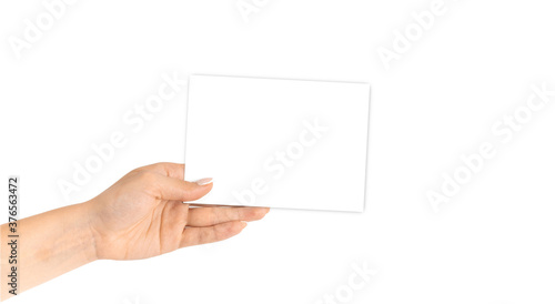 Business card mockup. Hand holding blank business paper card isolated on white background. Banner with copy space. Finger pointing.