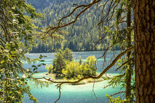 view on beautiful island in the eibsee in front of the zugspitze mountain