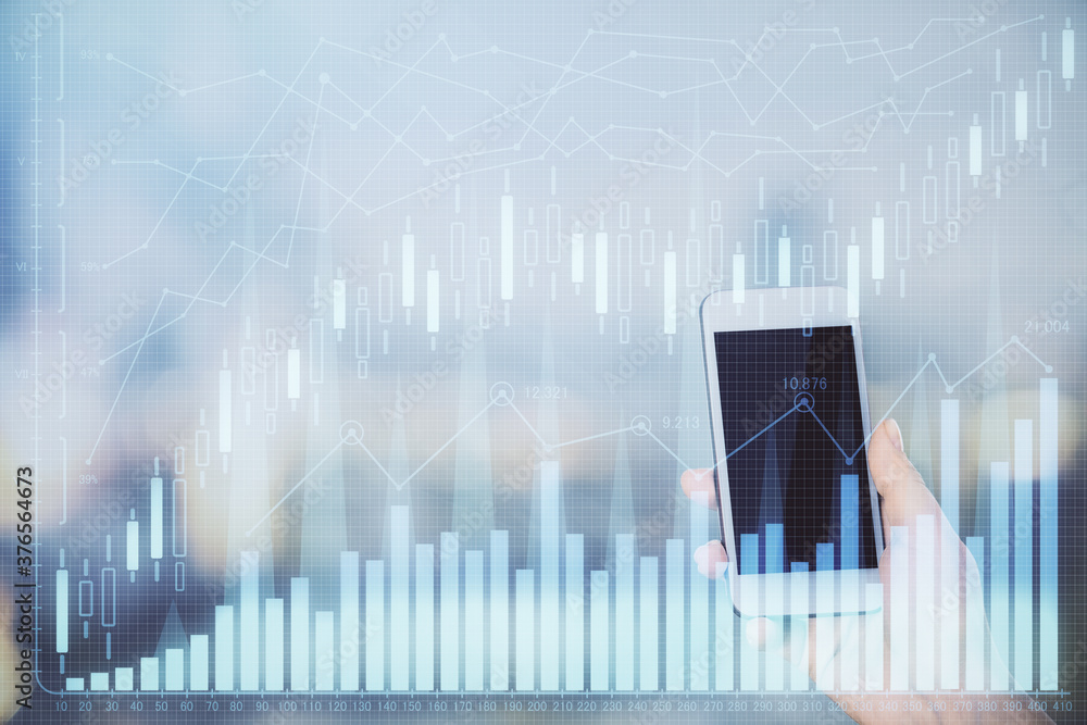 Double exposure of forex chart sketch hologram and woman holding and using a mobile device. Stock market concept. Double exposure of forex chart sketch hologram and woman holding and using a mobile device. Stock market concept.