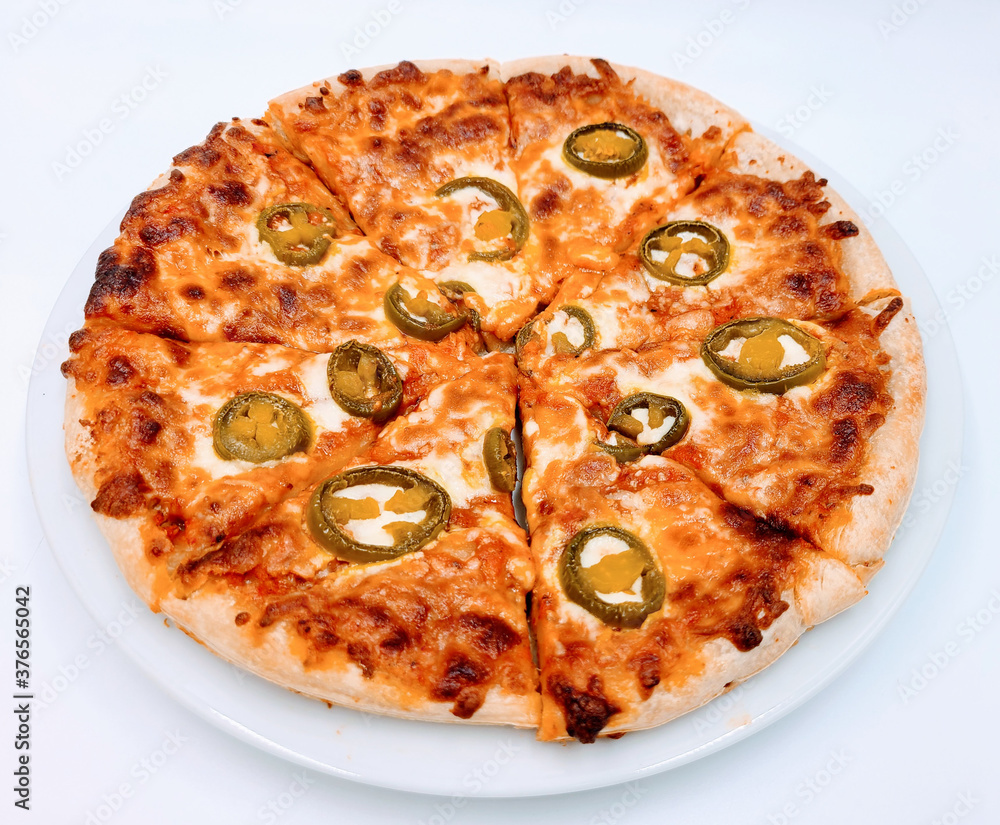 Homemade pizza ; Jalapenos pickle on cheese pizza crust on white plate in white background Homemade pizza ; Jalapenos pickle on cheese pizza crust on white plate in white background