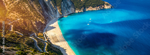 Aerial drone view of iconic turquoise and sapphire bay and beach of Myrtos, Kefalonia (Cephalonia) island, Ionian, Greece. Myrtos beach, Kefalonia island, Greece. Beautiful view of Myrtos beach. photo