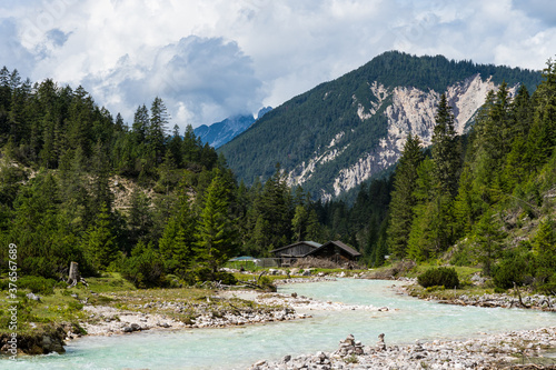 view on isar river and mountains near the isar origin in scharnitz, austria
