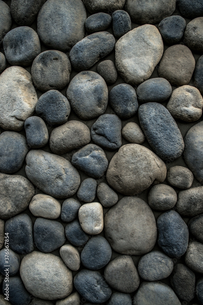 Stone background. Wall of rounded pebbles. Stone background. Wall of rounded pebbles.