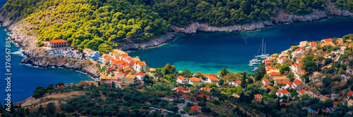 Assos village in Kefalonia, Greece. Turquoise colored bay in Mediterranean sea with beautiful colorful houses in Assos village in Kefalonia, Greece, Ionian island, Cephalonia, Assos village.
