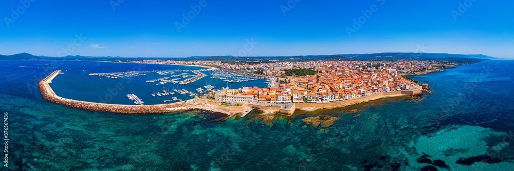Aerial view over Alghero old town, cityscape Alghero view on a beautiful day with harbor and open sea in view. Alghero, Italy. Panoramic aerial view of Alghero, Sardinia, Italy.
