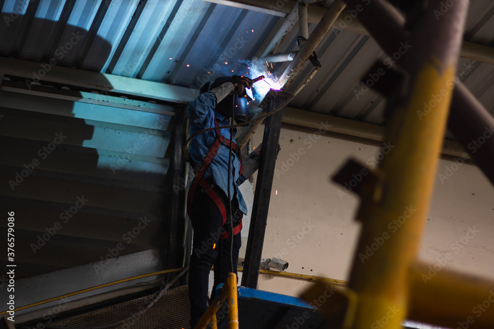 Metal workers use manual labor. Skilled welder. Welder is welding the steel in the factory. welder Industrial automotive part in factory. Metal workers use manual labor. Skilled welder. Welder is welding the steel in the factory. welder Industrial automotive part in factory.