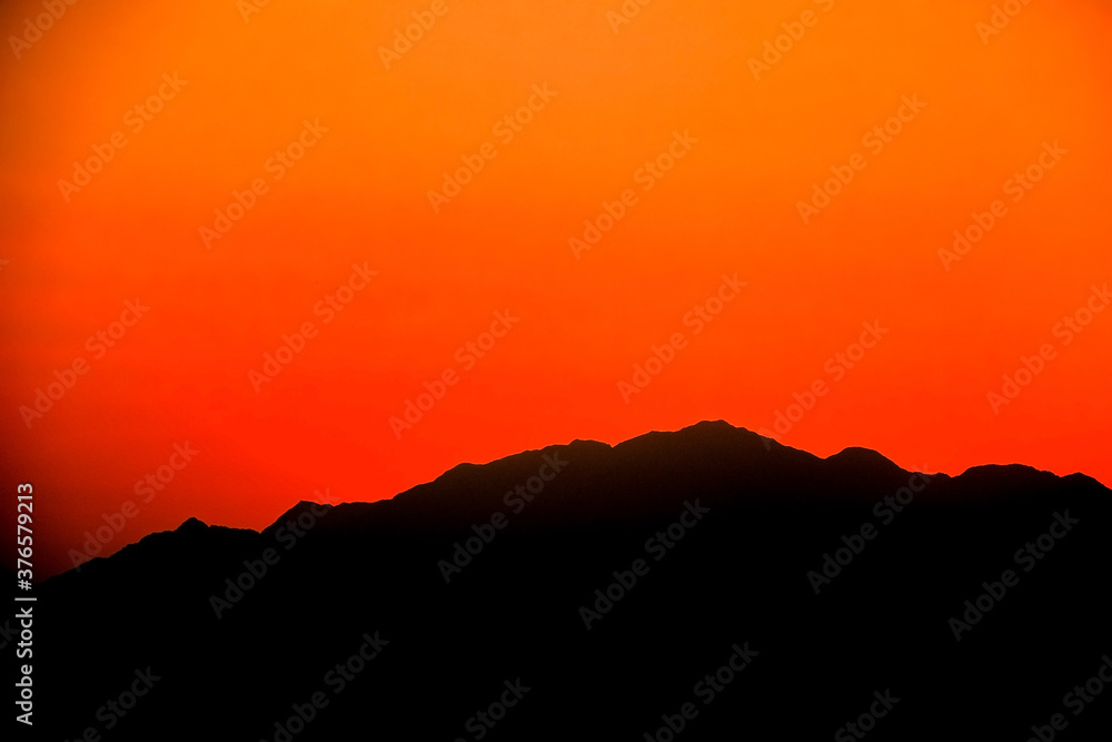 Silhouettes of mountains on the background of sunset, solar eclipse.