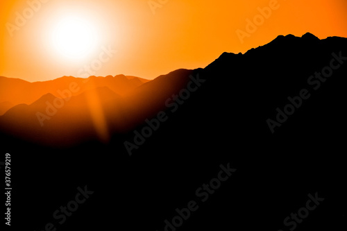 Silhouettes of mountains on the background of sunset  solar eclipse.