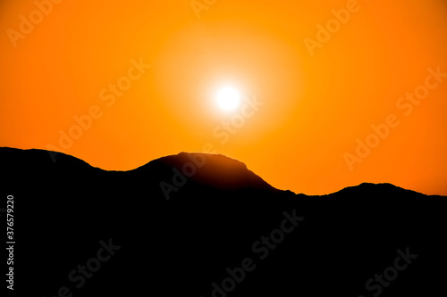 Silhouettes of mountains on the background of sunset, solar eclipse.