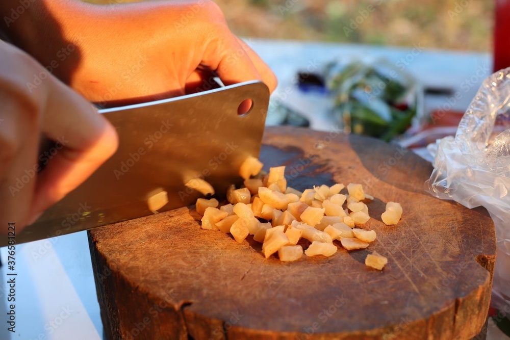 Chef cutting pickles on a cutting board Chef cutting pickles on a cutting board