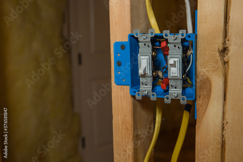 Blue Plastic Electical Box with Off and On Switch on new home construction framing
