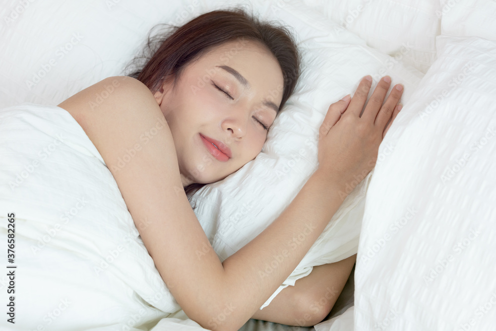 Asian women sleeping and sweet dream on white bed in bedroom Asian women sleeping and sweet dream on white bed in bedroom