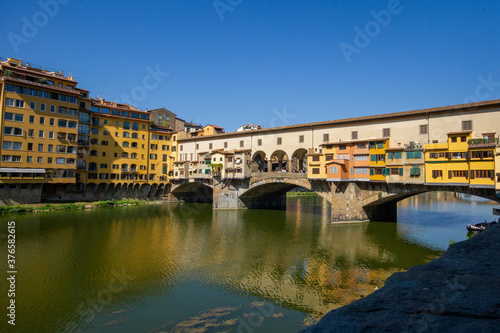 Reflection of Ponte Vecchio in Arno River in Florence, Italy