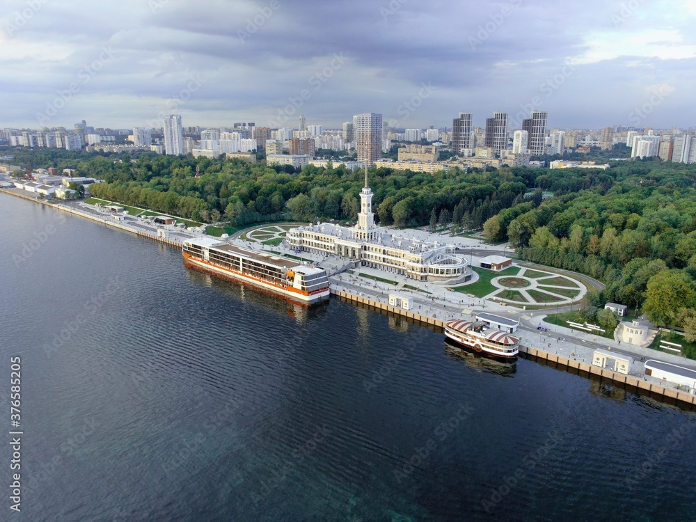 Aerial view is a beautiful panorama of the renovated Northern River Station in Moscow. Colorful landscape of the city and the river at sunset. River cruises