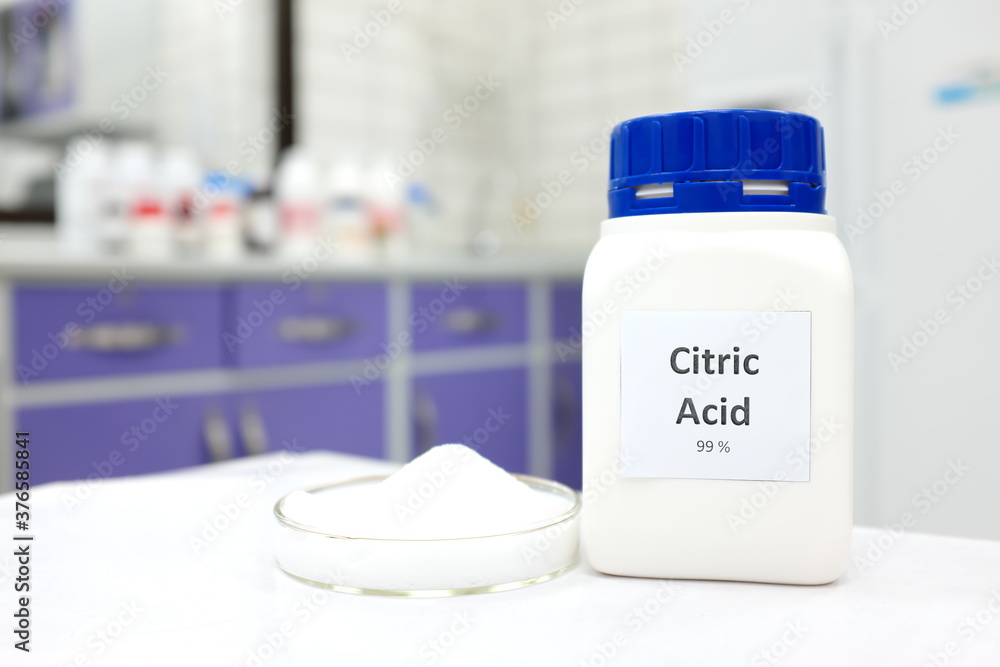 Ταπετσαρία Selective focus of a bottle of citric acid beside a petri dish with white crystalline powder substance