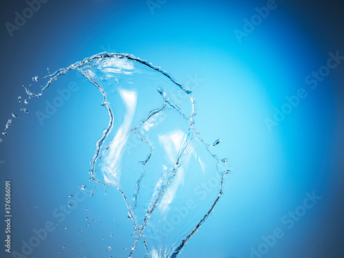 Obraz na plátně Water splash on blue background