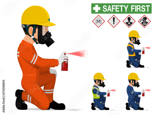 An industrial worker with respirator is spraying color