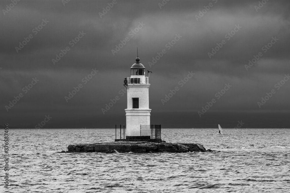 lighthouse on Cape Tokarevskaya cat in Vladivostok on the background of the sea in cloudy weather lighthouse on Cape Tokarevskaya cat in Vladivostok on the background of the sea in cloudy weather