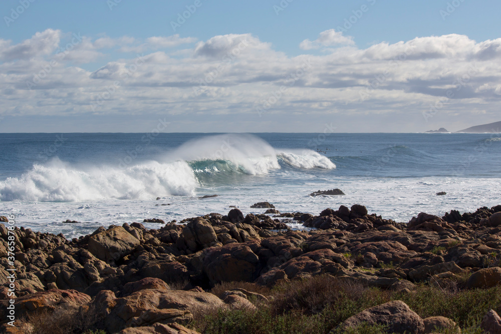 Huge  frothy waves of the Indian Ocean rolling in at famous Yallingup Beach,South Western Australia a world famous surfing mecca, on a cold yet sunny late winter morning.