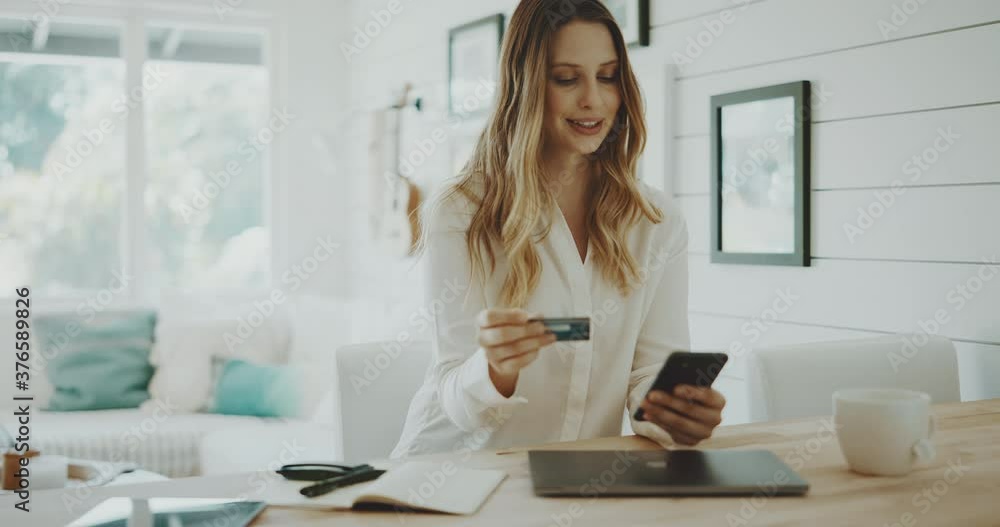 Attractive young woman shopping online from the comfort of her own home Attractive young woman shopping online from the comfort of her own home