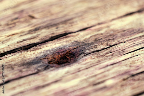 Decorative background, a hole from a rusty nail in a board