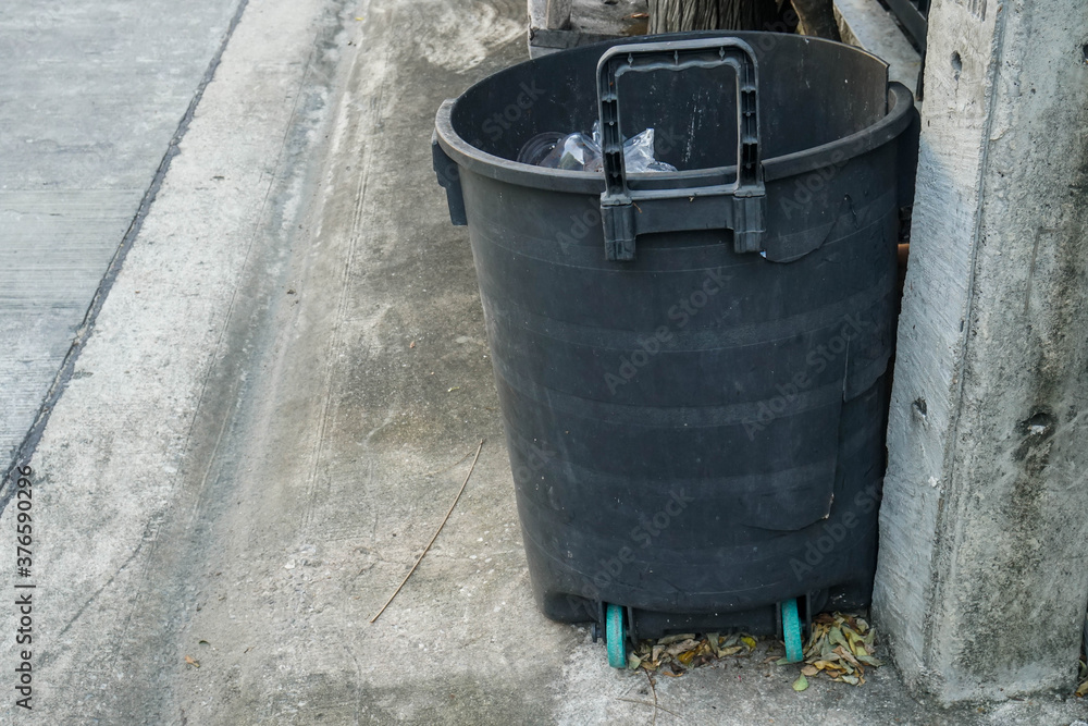 black plastic trash bin in front of the house black plastic trash bin in front of the house