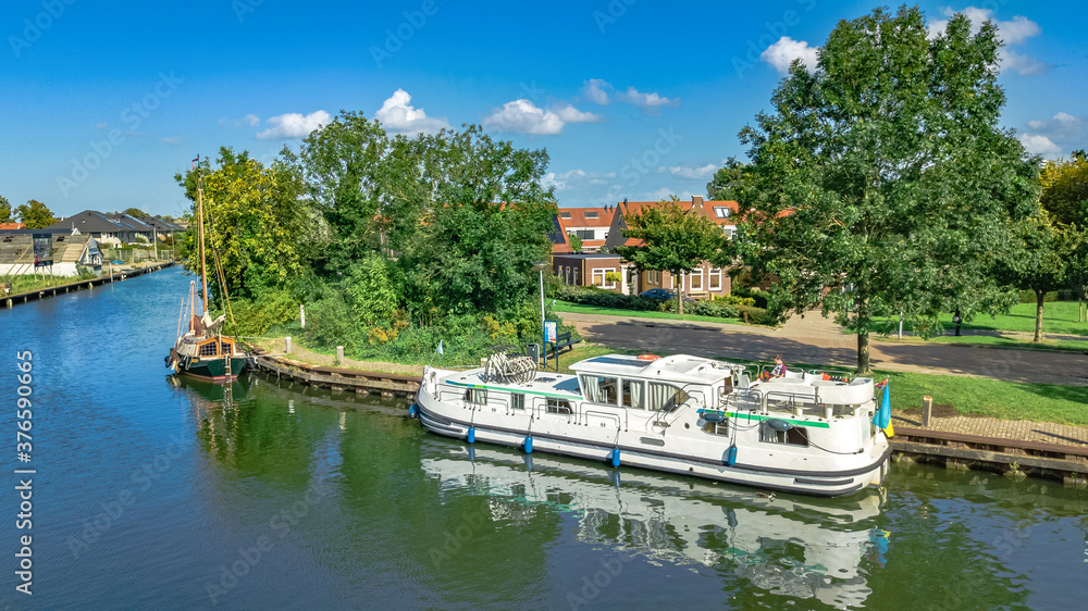 Houseboat travel in canal in typical Dutch village in countryside, cruise boat vacation in Netherlands
Houseboat travel in canal in typical Dutch village in countryside, cruise boat vacation in Netherlands