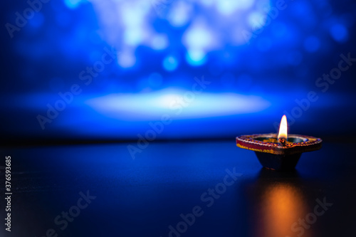 Indian festival Diwali  Diya oil lamps lit on colorful rangoli. Hindu traditional. Happy Deepavali. Copy space for text.