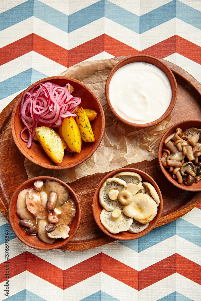 Snack assortment on wooden tray side view