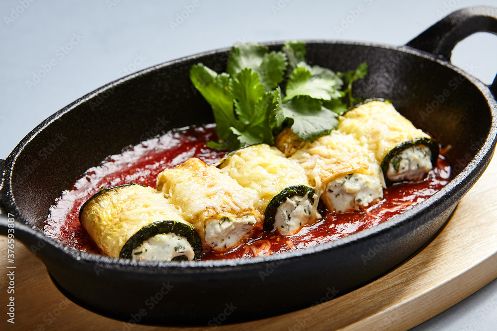 Eggplant rolls with cheese in tomato sauce