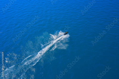 Drone view of a scooter. Top view of a water scooter in the blue sea. Aerial view of a scooter on blue water. luxury motor scooter.
