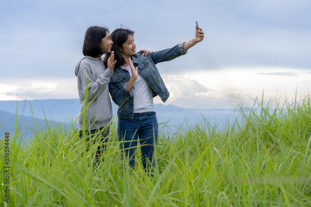 Tourist. group teen Asian woman social media taking photo selfie and vlogger live streaming video online at Phu Pa PO or Fuji Loei of Thailand