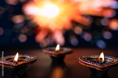 Indian festival Diwali, Diya oil lamps lit on colorful rangoli. Hindu traditional. Happy Deepavali. Copy space for text.