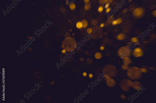 Fantasy gold bokeh sparkle from light on black © pandaclub23