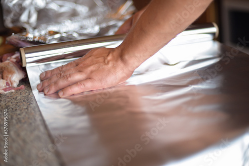 the process of cooking meat with vegetables wrapped in foil, on the grill at home, with your own hands, on an autumn day