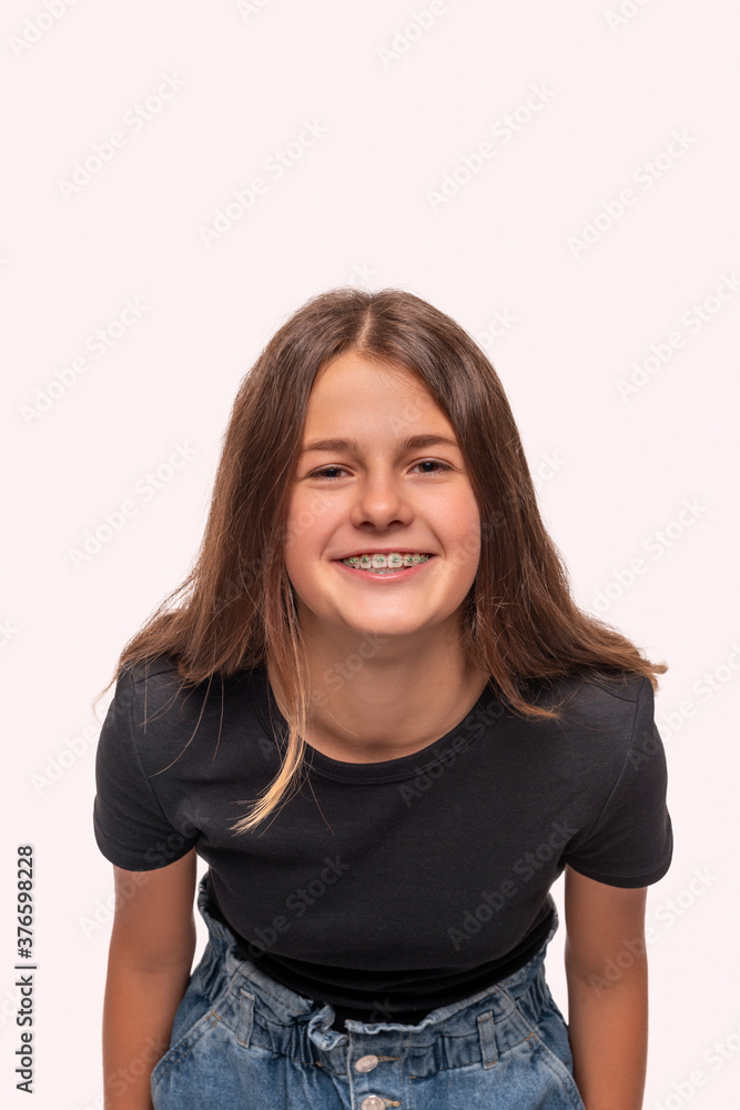 Studio shot of young smiling teenager girl with braces, isolated Studio shot of young smiling teenager girl with braces, isolated