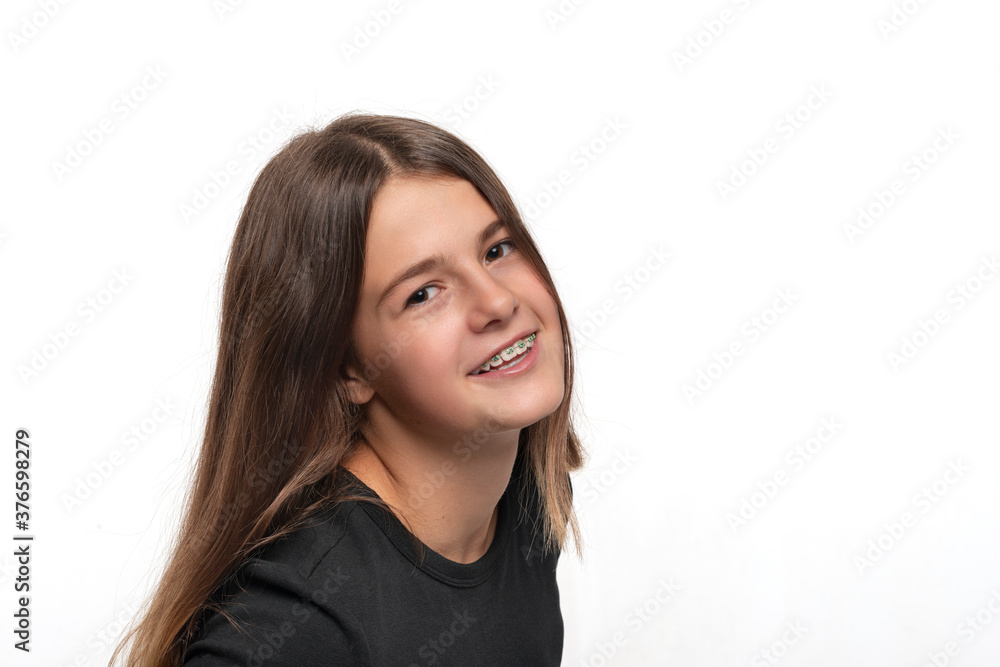 Studio shot of young smiling teenager girl with braces, isolated Studio shot of young smiling teenager girl with braces, isolated