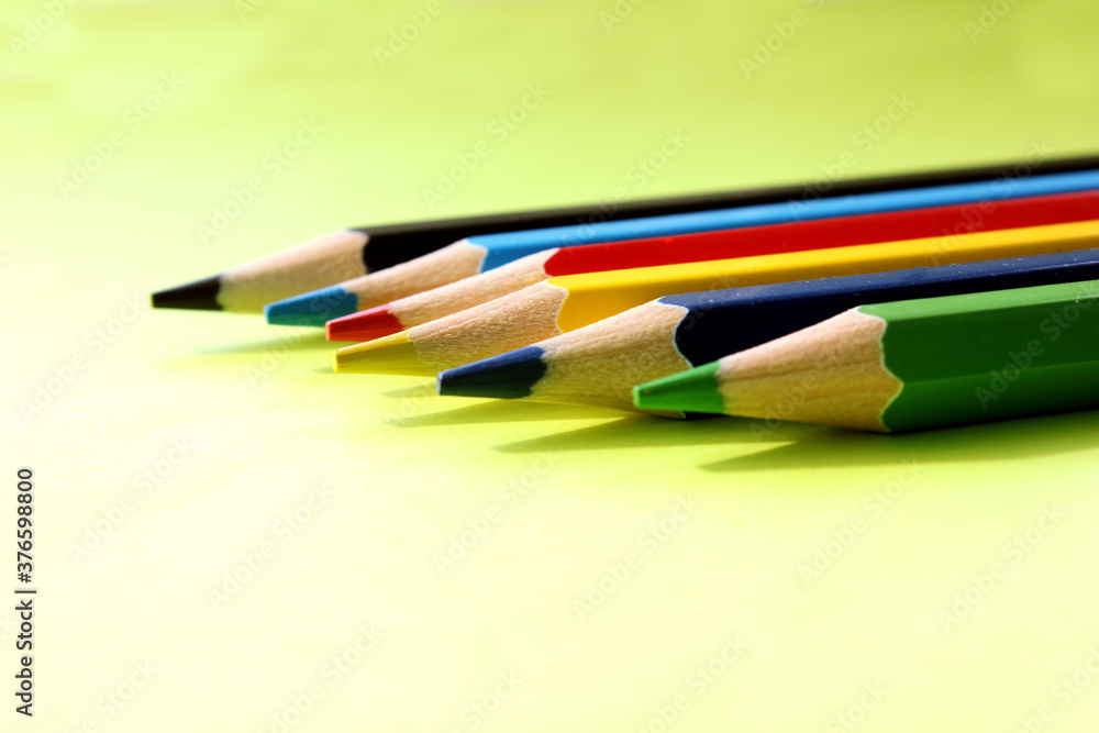 Colored pencils on a yellow background. Lots of different colored pencils. Colored pencil. Pencils are very sharp. Pencils are on the right. Side view. Close-up. Copy space. Background. Flat lay. Colored pencils on a yellow background. Lots of different colored pencils. Colored pencil. Pencils are very sharp. Pencils are on the right. Side view. Close-up. Copy space. Background. Flat lay.