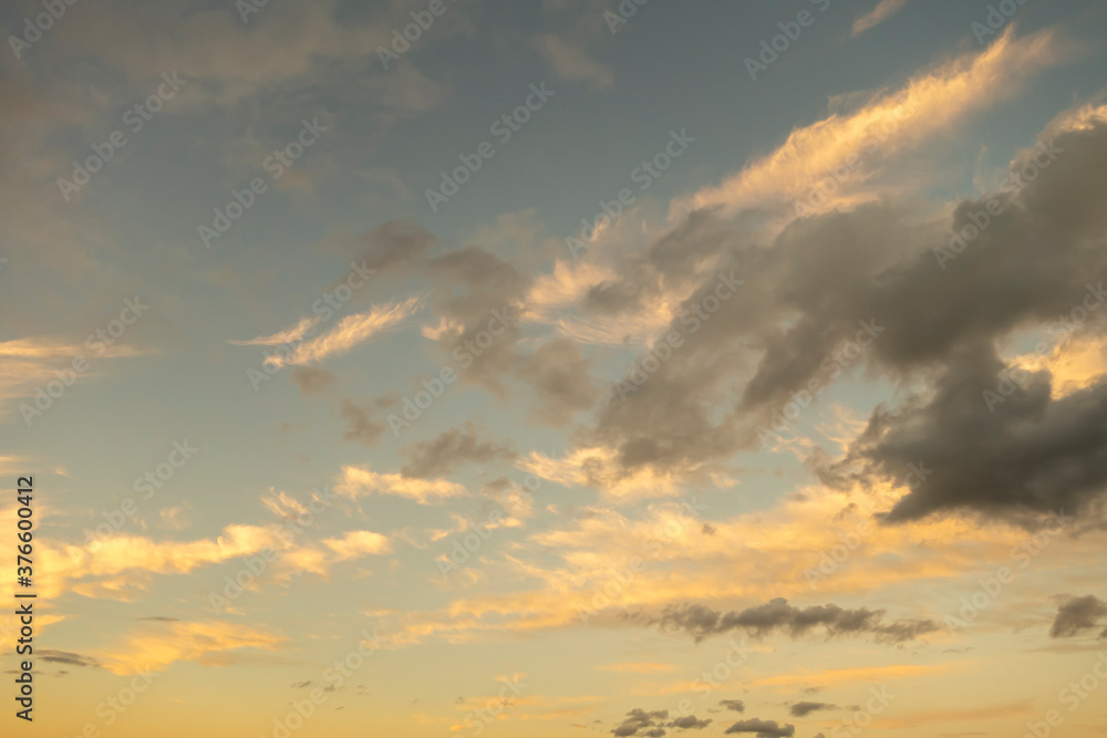 sunset sunrise clouds with dark and light yellow blue coloring cloudscape