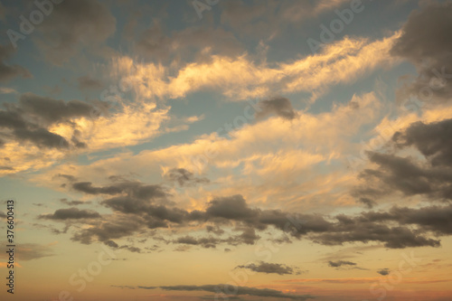 sunset sunrise clouds with dark and light yellow blue coloring cloudscape © Mirror-images