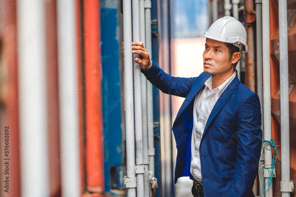 Professional engineer container cargo foreman in helmets working standing and checking stock into container for loading.logistic and business export Professional engineer container cargo foreman in helmets working standing and checking stock into container for loading.logistic and business export