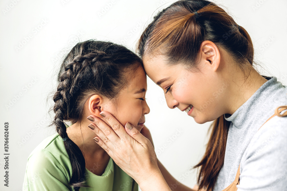 Portrait of enjoy happy love asian family mother and little asian girls child smiling and having fun touching face with cute kid daughter moments good time Portrait of enjoy happy love asian family mother and little asian girls child smiling and having fun touching face with cute kid daughter moments good time