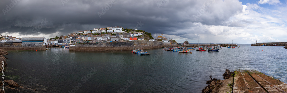 Panoramic view of the harbour at Mevagissey in Cornwall on a dramatic stormy summer afternoon
