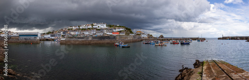 Panoramic view of the harbour at Mevagissey in Cornwall on a dramatic stormy summer afternoon