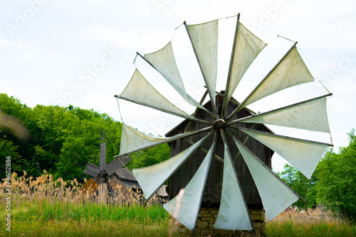 wooden windmill on the plain behind the house
