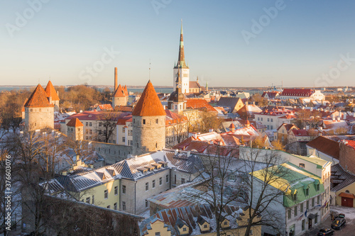 Tallinn old town rooftop view in winter. Blue sky and evening sunlight.