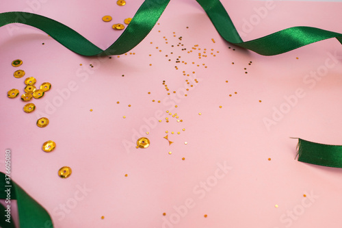 on a pink background is a green ribbon that frames the center with yellow confetti. Greeting card layout for greetings photo