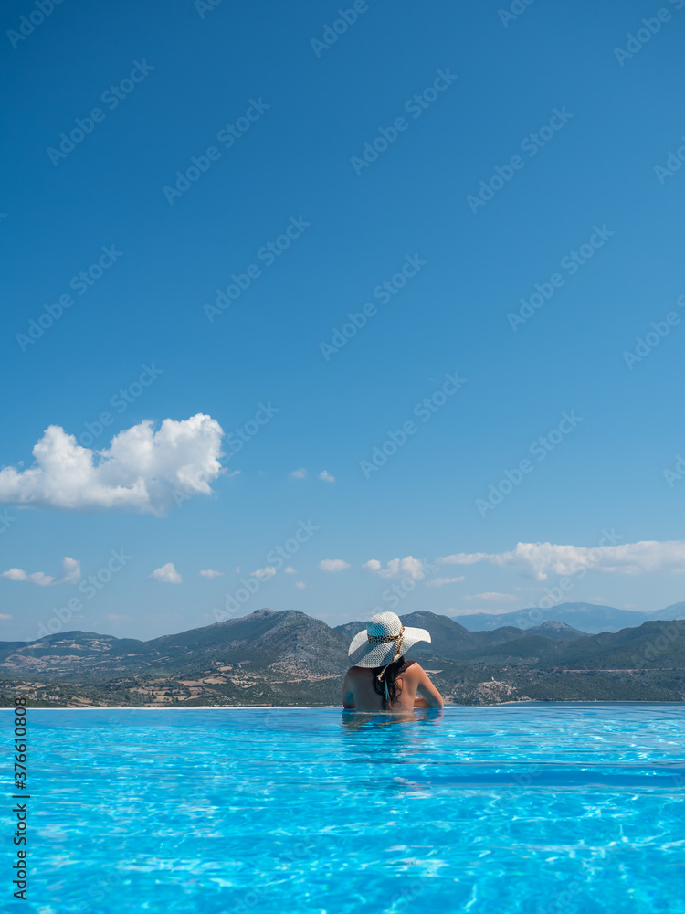 Woman at the infinity swimming pool