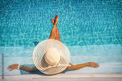woman in luxury spa resort near the swimming pool.